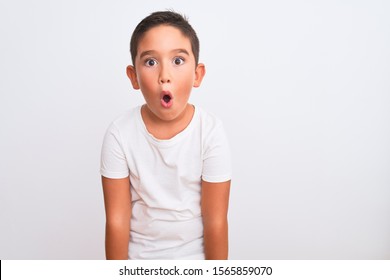 Beautiful Kid Boy Wearing Casual T-shirt Standing Over Isolated White Background Afraid And Shocked With Surprise Expression, Fear And Excited Face.