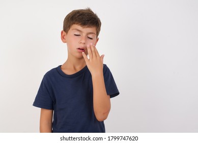 Beautiful Kid Boy Wearing Casual T-shirt Standing Over Isolated White Background Being Tired And Yawning After Spending All Day At Work.