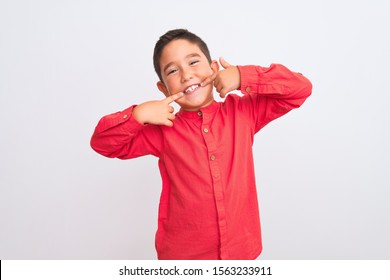 Beautiful Kid Boy Wearing Elegant Red Shirt Standing Over Isolated White Background Smiling Cheerful Showing And Pointing With Fingers Teeth And Mouth. Dental Health Concept.