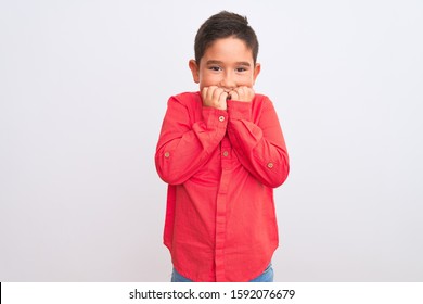 Beautiful Kid Boy Wearing Elegant Red Shirt Standing Over Isolated White Background Looking Stressed And Nervous With Hands On Mouth Biting Nails. Anxiety Problem.