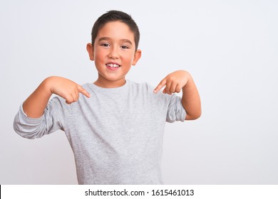 Beautiful kid boy wearing grey casual t-shirt standing over isolated white background looking confident with smile on face, pointing oneself with fingers proud and happy.