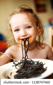 Beautiful Kid Eating Black Spaghetti