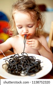 Beautiful Kid Eating Black Spaghetti