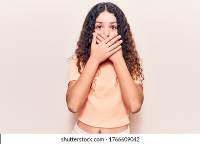 Beautiful Kid Girl With Curly Hair Wearing Casual Clothes Shocked Covering Mouth With Hands For Mistake. Secret Concept. 