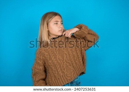Beautiful kid girl wearing brown knitted sweater stressed, anxious, tired and frustrated, pulling shirt neck, looking frustrated with problem