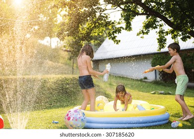 Beautiful kids having fun outside in the summer garden