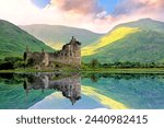 Beautiful Kilchurn Castle on Lock Awe in the highlands of Scotland at sunset with reflections