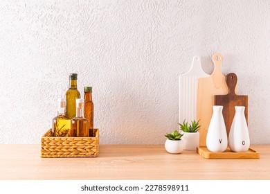 Beautiful kitchen background with various bottles of oil for cooking on a wooden countertop. front view. space for text - Shutterstock ID 2278598911