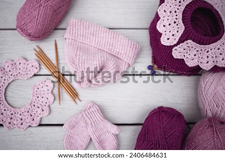 beautiful knitted and crochet background with handcrafted accessories and wool yarn in pink and mulberry palette