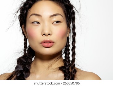 Beautiful Korean model with long hair styled into chaotic hairdo with many stray hairs.