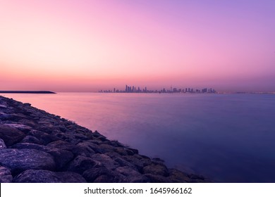 Beautiful Kuwait Skyline View At Morning Sun Rise With Beach Rocks