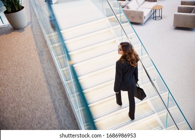 Beautiful lady with bag walking up the stairs stock photo - Powered by Shutterstock