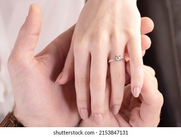 Beautiful lady hand. The background is white and a diamond ring on your finger. - Shutterstock ID 2153847131