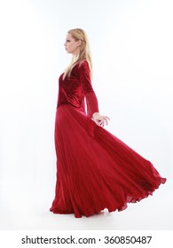 beautiful lady with long blonde hair wearing a red medieval fantasy gown. standing, isolated on white background.