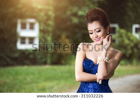 Beautiful lady in luxury blue dress