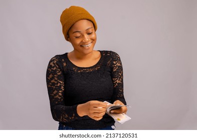 beautiful lady smiling over white background smiling as she counts money - Powered by Shutterstock