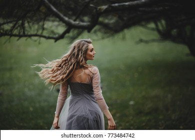 The beautiful lady walking near trees