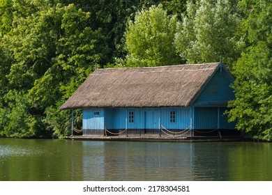 A Beautiful Lake House Bounded By The Green Forest On A Beautiful Summer Day