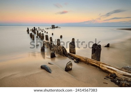 Beautiful Lake Michigan at dusk with a long exposure so the water is a mystical teal feel. Taken in the northern suburbs of Chicago, what is left of Evanston Pier.