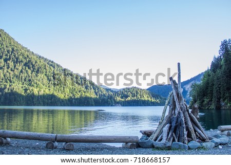 Beautiful lake ritsa in Abkhazia. Landscape of the mountains of the forest and the lake.Firewood stacked for ignition
