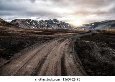 Beautiful Landmanalaugar gravel dust road way on highland of Iceland, Europe. Muddy tough terrain for extreme 4WD 4x4 vehicle. Landmanalaugar landscape is famous for nature trekking and hiking. - Shutterstock ID 1360762493