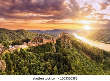 Beautiful landscape with Aggstein castle ruin and Danube river at sunset in Wachau walley Austria. Amazing historical ruins. Original german name is Burgruine aggstein. Little castle in english.