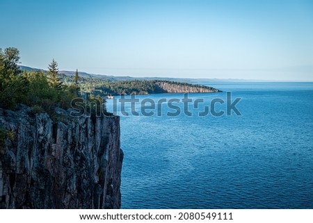 Beautiful landscape along the north shore of Lake Superior in Minnesota, from Palisade Head, a natural sheer cliff at the edge of the blue water. Evening image at the shore of Gitchi-Gami.