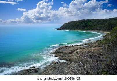 Beautiful landscape beach with rocky shore and clouds, Noosa Heads, Sunshine Coast, Australia
