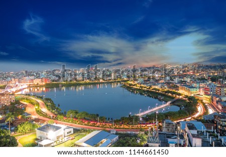 Beautiful landscape of blue cinematic sky, buildings, road, car lighting, evening lighting of Dhaka City, Bangladesh - Hatirjheel lakefront view  