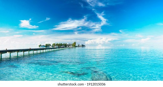 Beautiful Landscape With Bridge To Pier. Color Fusion Of Ocean And Sky. Light Ripples On Amazingly Clear Water. Perspective Receding Into Distance. Image Fine Vacation On Summer. Relax And Rest.