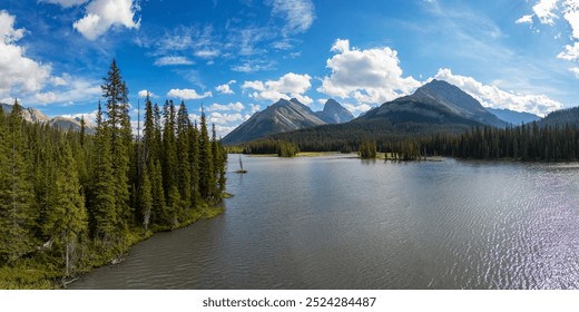 Beautiful landscape of the Canadian Rockies in Canada featuring a tranquil lake, lush pine forest, and clear blue sky, offering a peaceful and picturesque nature scene. - Powered by Shutterstock