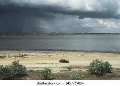 Beautiful landscape with clouds and roads. Rain clouds over the water. Wild nature. Desert landscape. The sky before the storm. Lyman Kuyalnik. Ukraine, Odessa.