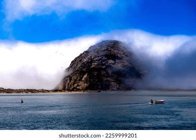 A beautiful landscape displaying the Morro rock in Morro bay, California along a blue seascape