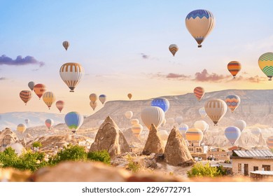 Beautiful landscape of fabulous scenic Kapadokya, Nevsehir. Colorful fairy flying air balloons in sky at sunrise in Anatolia, Goreme  - Powered by Shutterstock