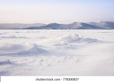 Beautiful landscape of frozen lake covered with snow and ice. Turgoyak Lake in Southern Urals, Russia. - Powered by Shutterstock