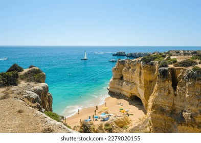 Beautiful landscape with golden limestone cliffs, Atlantic ocean and  Rabbit Beach (Praia da Coelha) in Albufeira, District Faro, Algarve, Southern Portugal