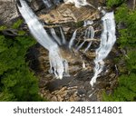 Beautiful landscape of high waterfall with falling down clear water from rocky boulders between green lush woods. Whitewater Falls in Nantahala National Forest, North Carolina, USA