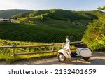 Beautiful landscape of hills with vineyards with vintage Italian Vespa, green rural environment in the countryside of Italy. Valdobbiadene Prosecco area, vines emotional pictures