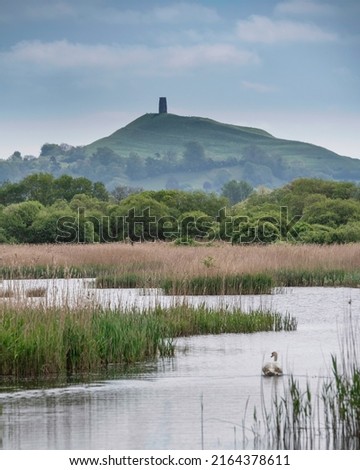 Beautiful landscape image of Glastonbury Tor in Somerset during Spring sunrise over the Levels