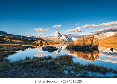 Beautiful landscape of Lake Stellisee with Matterhorn iconic mountain, Swiss alps and stones reflection in the morning at Zermatt, Switzerland - Shutterstock ID 2394515125