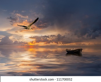 Beautiful landscape with lonely boat and birds against a sunset, majestic clouds in the sky - Powered by Shutterstock