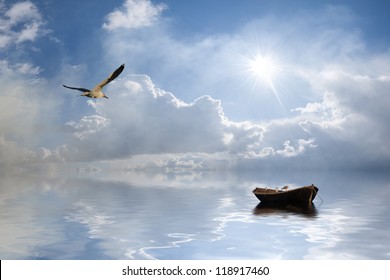 Beautiful landscape with lonely boat and birds against a sun, majestic clouds in the sky - Powered by Shutterstock