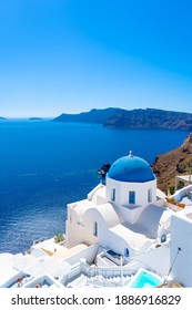 Beautiful landscape from Oia town on Santorini island, Greece. Traditional and famous houses and churches with blue domes over the Caldera, Aegean sea - Shutterstock ID 1886916829