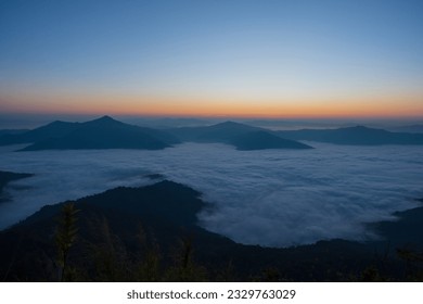Beautiful landscape on the mountains against sky during sunrise. Spectacular view in foggy valley covered forest under morning sky. Countryside landscape view background.