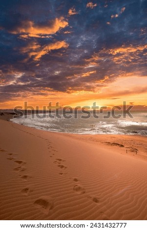 Beautiful landscape with orange sunset in the Taroa dunas and sea view. Guajira, Colombia. 