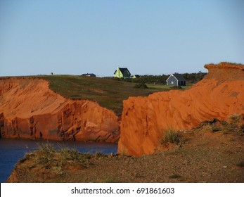 Beautiful Landscape Of Painted Houses On Top Of Red Cliffs In Magdalene Islands, Iles De La Madeleine, Quebec, Canada