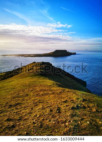 Beautiful landscape photo of Pen Pyrod island, Worms Head, The Gower in Wales, UK
