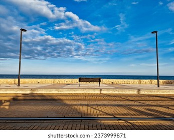 beautiful landscape seaside promenade with bench without people Alicante Spain - Powered by Shutterstock