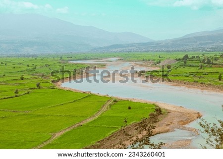 A beautiful landscape of the Sefid Roud (Sefid-Rud) river and agricultural fields around it, in Gilan province of Iran. Rice farms around Sefid Rud river near Rasht city.