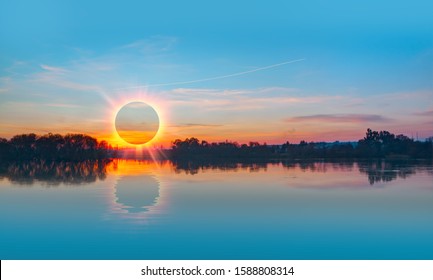 Beautiful landscape with Solar Eclipse over the lake at sunset